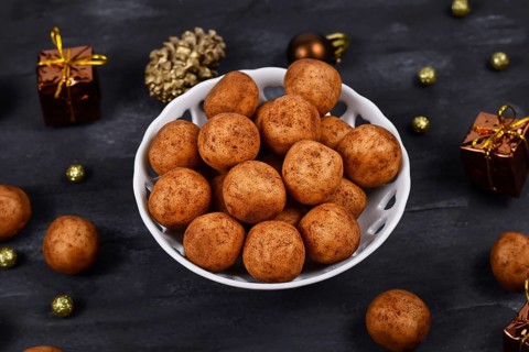 Traditional German Christmas sweets called Marzipankartoffeln. Round ball shaped almond paste