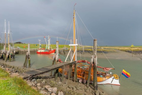 Traditional sailing ships and fishing boats in the harbour, Süderhafen, rainbow, dike foreland,