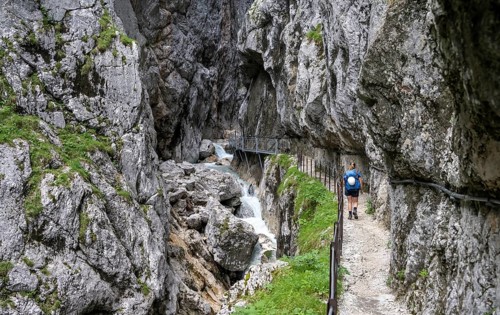 Hiker in a gorge, Hammersbach flows through Höllentalklamm, near Garmisch-Partenkirchen,