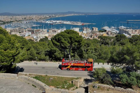 Tourist bus at Bellver Castle, Palma de Mallorca behind, Majorca, Balearic Islands, Spain, Europe