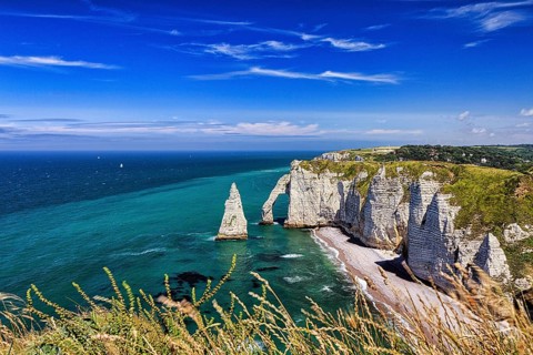 View from above of striking chalk cliffs, rock arch Porte dAval and rock needle Aiguille, Etretat,