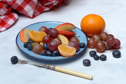 Various pieces of fruit on plate, fruit salad
