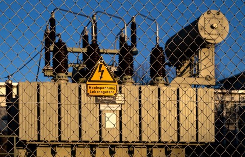High-voltage warning sign, danger to life, in front of capacitors in substation, transformer,