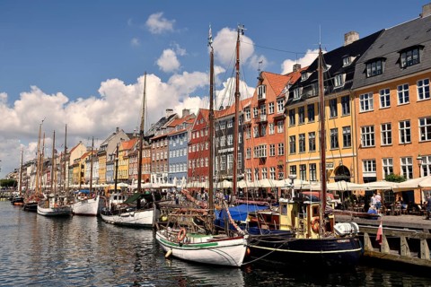 Sailing boats on the canal in front of colorful facades, Nyhavn, Copenhagen, Denmark, Europe
