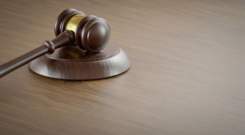 Gavel resting on a table with room for text