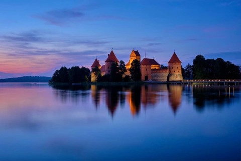 Trakai Island Castle in lake Galve illuminated in night, Lithuania, Europe