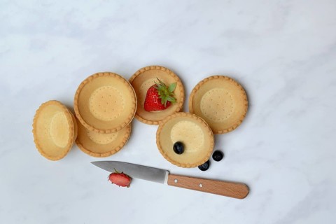 Tartelette, pre-made tartlet base with strawberry, blueberry and kitchen knife