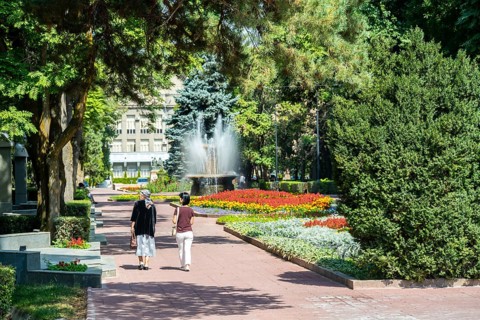 Strollers, flower bed in Panfilov Park, municipal park in Bishkek, Kyrgyzstan, Asia