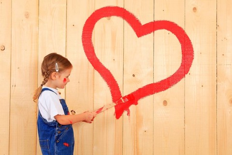 Girl paints, paints heart, with brush, Mother's Day