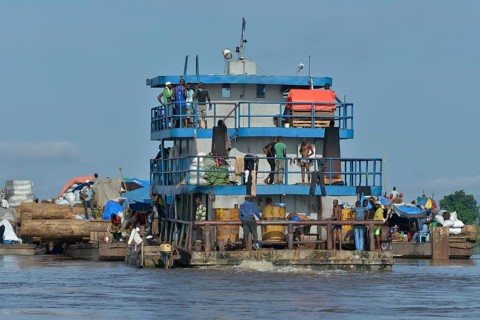 Freighter transporting logs of tropical timber on the Congo River, near Kinshasa, Kinshasa