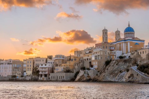 View of the village with the Greek Orthodox church of Agios Nikolaos, Asteria Beach, at sunset with