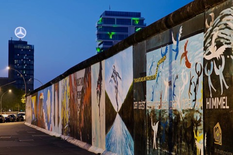 Mural on the Berlin Wall with Mercedes star, Berlin, Germany, East Side Gallery in the blue hour,