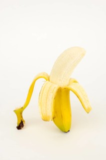 Half peeled banana, studio shot, white background, healthy diet