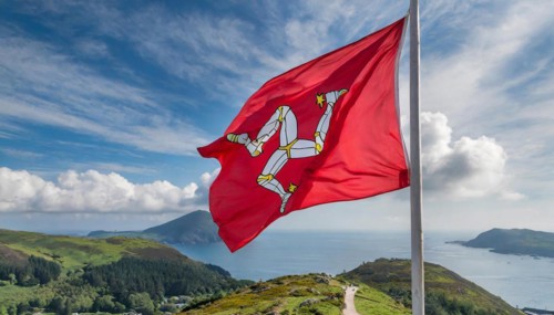The flag of the Isle of Man, Great Britain, flutters in the wind