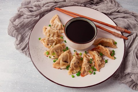 Japanese Gyoza dumplings, fried, with sauce, top view, without people, tinted, selective focus