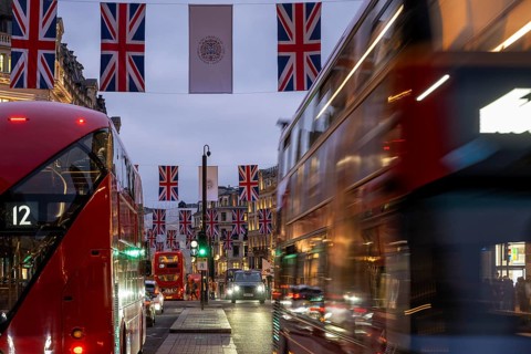 Red double-decker buses, English flags, evening mood, Oxford Circus, London, London region,