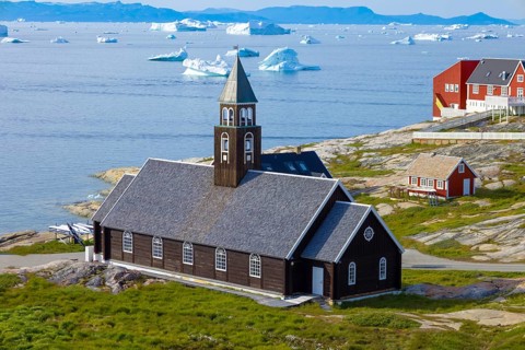 Typical architecture of Greenland Ilulissat with colored houses located near fjords and icebergs