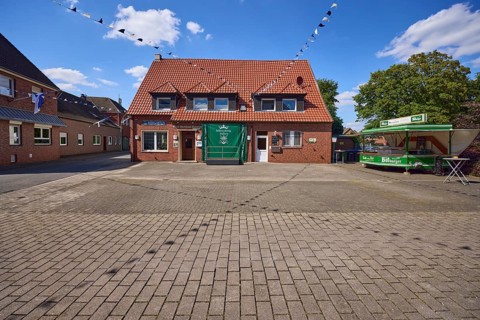 Old inn Kentrup and beer wagon with decorated fairground for the shooting festival in Buldern,