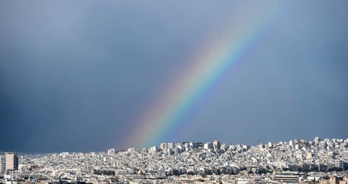 View over the sea of houses of Athens, with rainbow, Athens, Attica, Greece, Europe