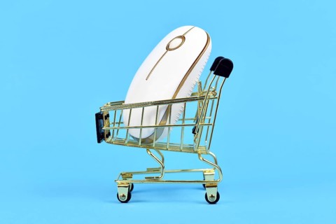 Online shopping concept with shopping cart with computer mouse