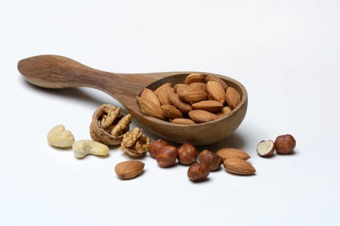 Wooden ladle with various nuts