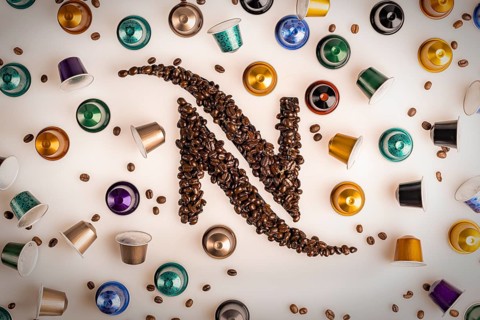 Food photography, Nespresso logo made from coffee beans with Nespresso capsules