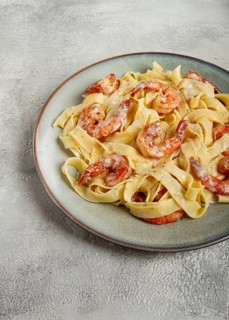 Tagliatelli with shrimp, in cream sauce, with parmesan cheese, homemade, no people, in