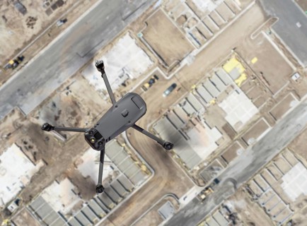 Unmanned aircraft system quadcopter drone UAV in the air over construction site.