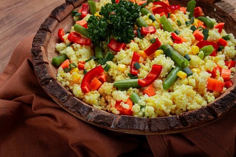 Couscous with vegetables, paprika, carrots, string beans, corn, homemade, top view, no people