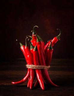 Bunch of red hot chili pepper, close-up, on a dark background, selective focus, no people, concept,