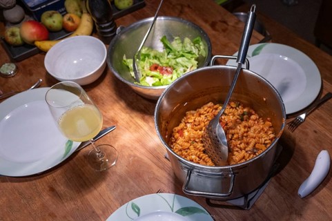 Salad and freshly cooked pasta with tomato sauce in a pot on the table, Baden-Württemberg, Germany,