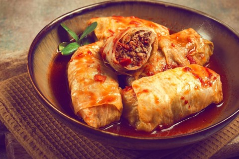 Stuffed cabbage rolls with minced meat, in tomato sauce, top view, without people, in the spotlight