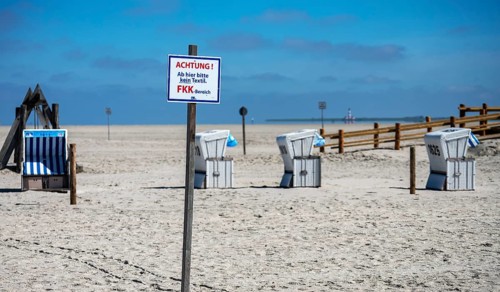 Beach chairs and signs on the sandy beach of the North Sea, Sankt Peter-Ording, Schleswig-Holstein,