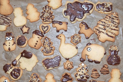 Various biscuits decorated with chocolate in the shape of Christmas trees, elephants and snowmen,
