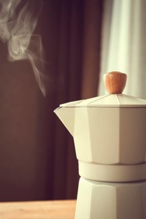 Geyser coffee maker, beige, close-up, boiling, steam from the spout, morning, breakfast, no people