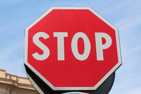 Close-up of red and white traffic stop sign made of reflective material, Messina, Sicily, Italy,