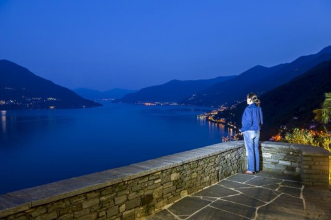 Woman Enjoy Panoramic View over Alpine Lake Maggiore with Mountain in Blue Hour in Ronco Sopra