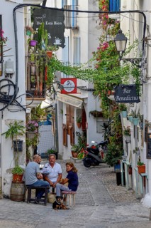 People in a sidewalk café in the old town of Peñíscola, Castellón province, Costa del Azahar,