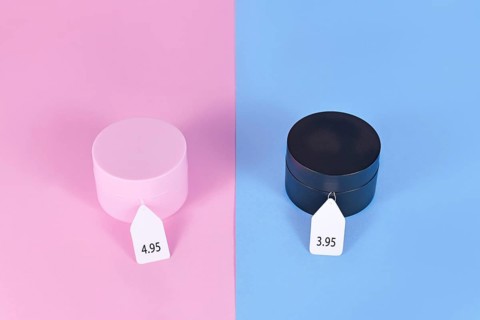 Pink tax concept showing pink and black facial cremes aimed at specific genders with different