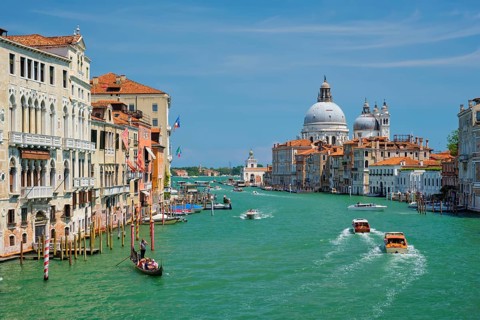 VENICE, ITALY, JULY 19, 2019: View of Venice Grand Canal with boats and Santa Maria della Salute