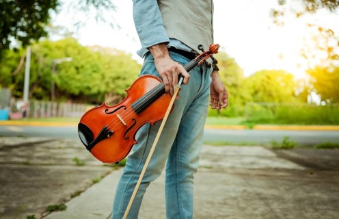 Hands holding violin and hoop outdoors, Close up of hands holding violin and hoop. Concept of
