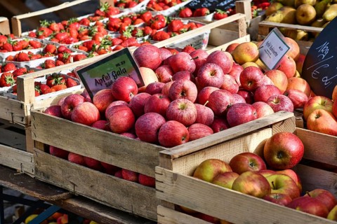 Freiburg, Germany, April 2022: Red Gala apples in baskets at market sales booth, Europe