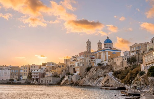 View of the village with the Greek Orthodox church of Agios Nikolaos, Asteria Beach, at sunset with