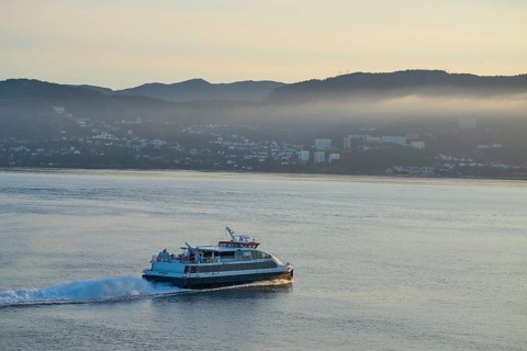 Ferry crossing the North Sea in the light of sunrise, with Bergen in the background, Bergen,