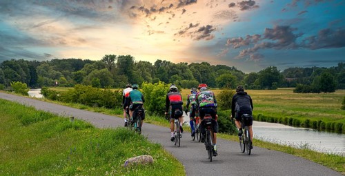 Cyclist on a cycle path by the river, landscape in the Lower Oder Valley National Park, Criewen,