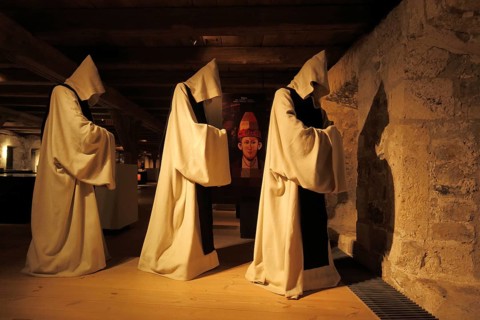 Three historical monks with monk's cowl and hoods in the museum, figures, cowl, Middle Ages,