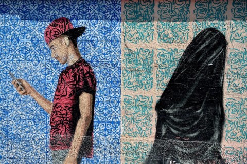 Mural of a veiled woman and a young man with a mobile phone, graffito, Al Khobar, ash-Sharqiyya