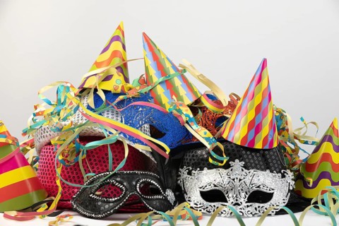Colourful party hats and carnival masks, decorated with colourful streamers, carnival