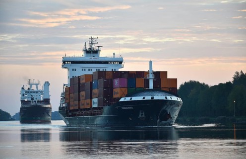 Container ship Nordic Porto sailing at sunrise in the Kiel Canal, Kiel Canal, Schleswig-Holstein,