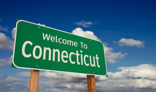 Welcome to connecticut green road sign over blue sky with some clouds